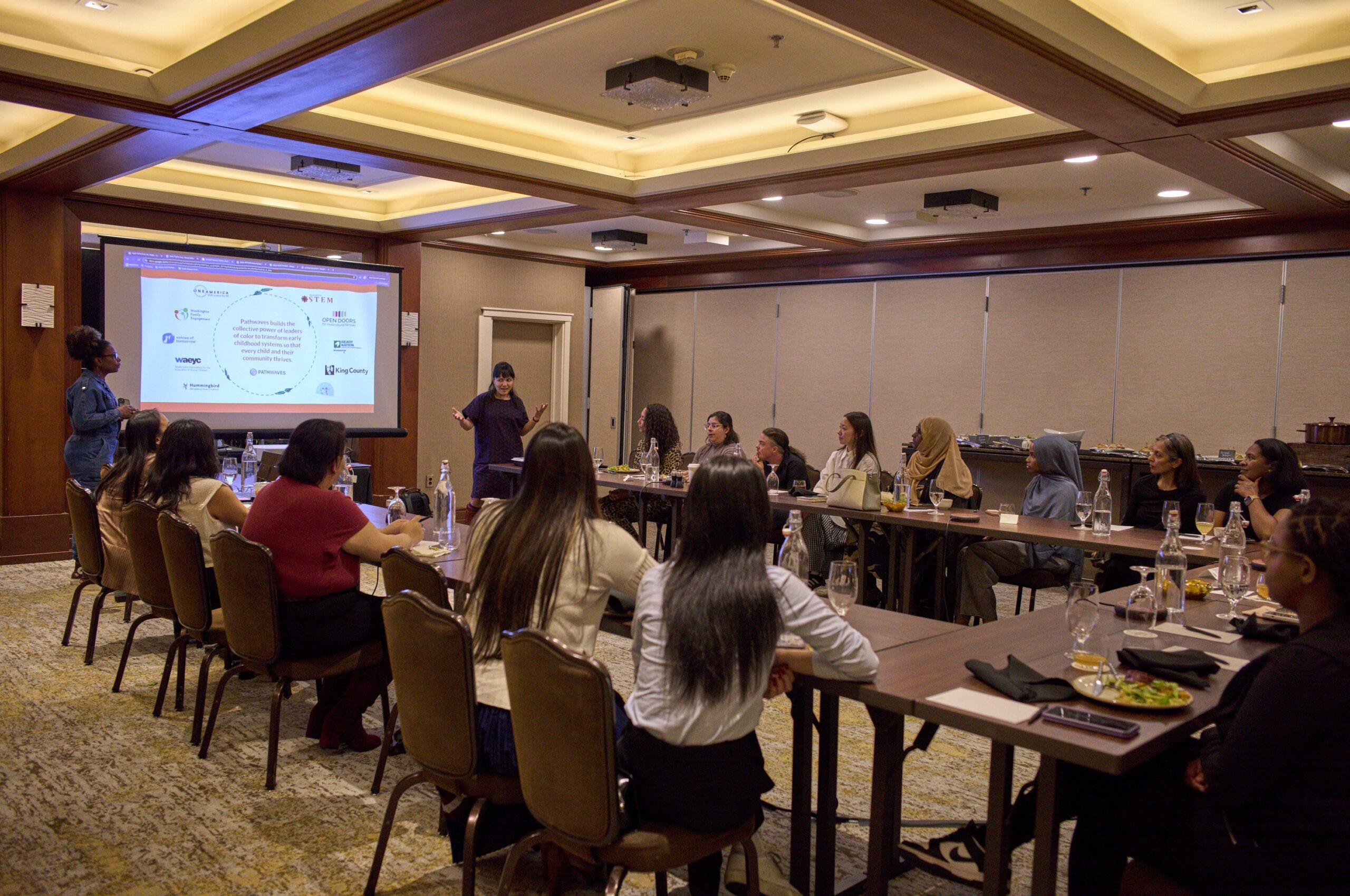 Leaders of color gather around a conference table