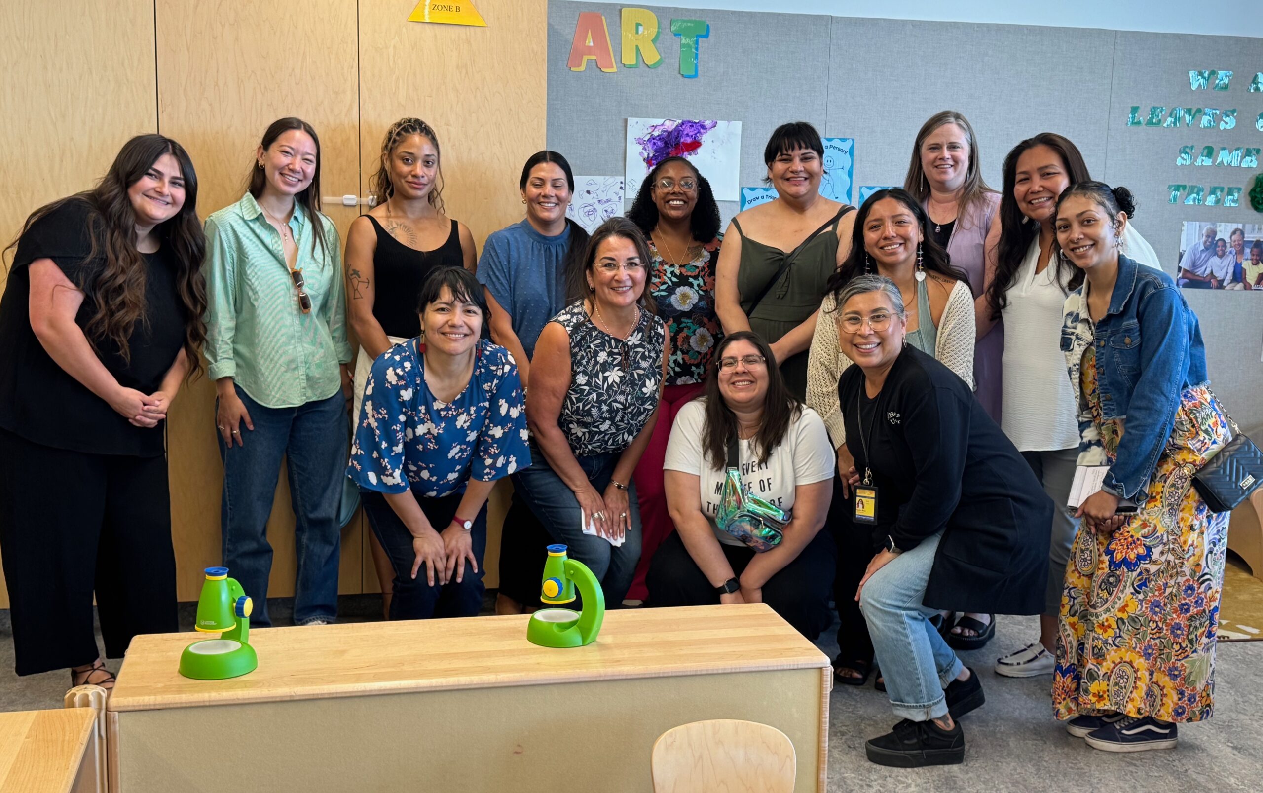 Pathwaves Fellows, staff, board, and child care providers pose together in a classroom during a field trip to Yakima
